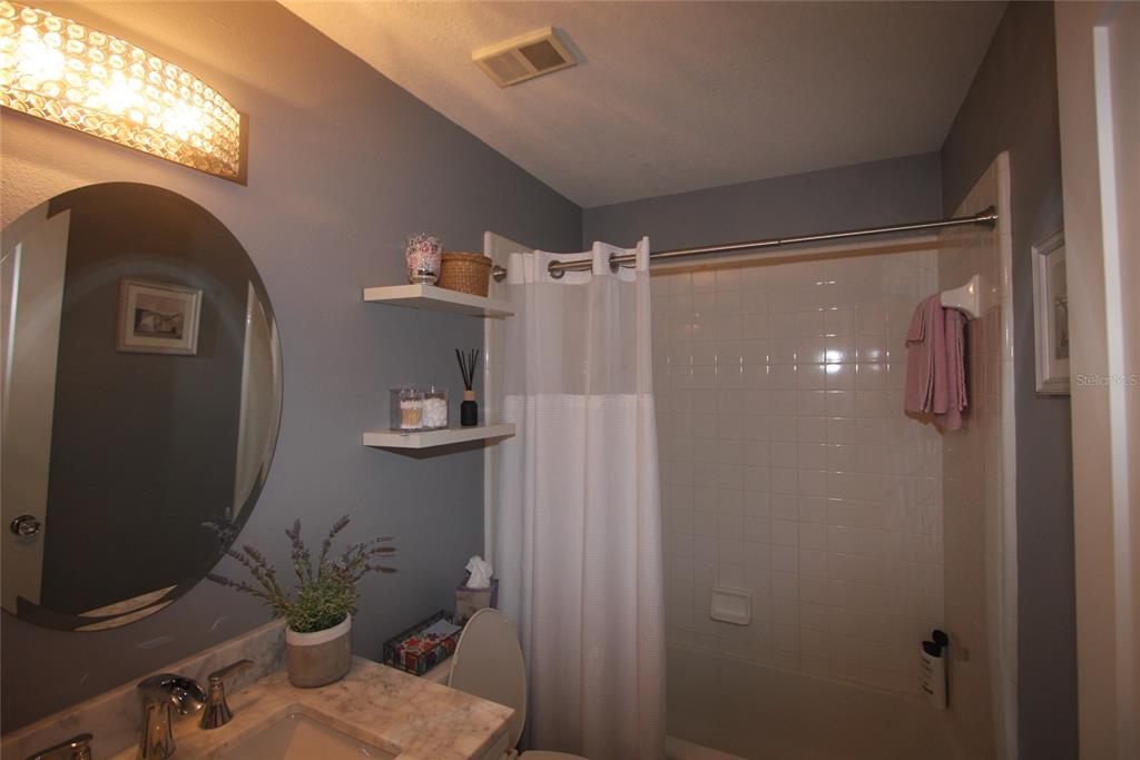 810 Loch Calder, Unit 25 Apopka, FL 32712 - Photo 16 of 24 a bathroom with a shower and a mirror
