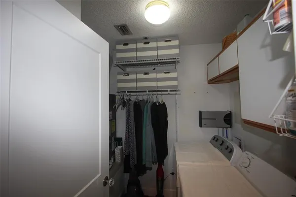 a view of a storage and utility room with racks on the wall