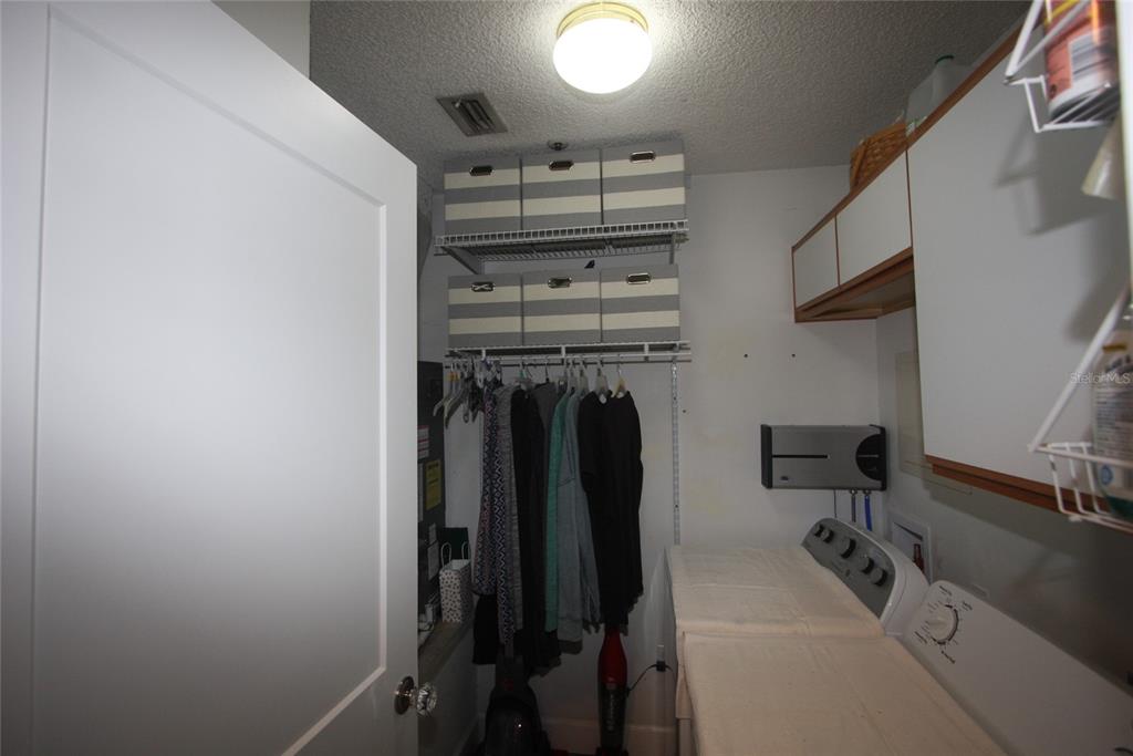 810 Loch Calder, Unit 25 Apopka, FL 32712 - Photo 17 of 24 a view of a storage and utility room with racks on the wall