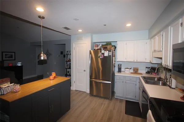 a kitchen with stainless steel appliances a refrigerator and a stove top oven