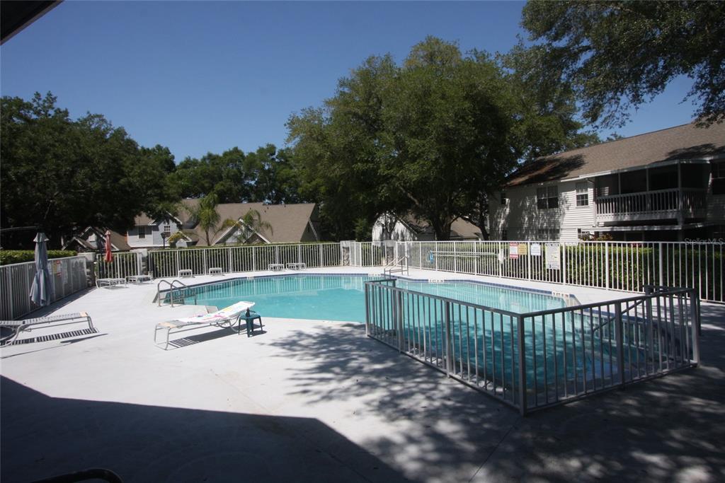 810 Loch Calder, Unit 25 Apopka, FL 32712 - Photo 24 of 24 a view of a wrought iron fences with trees in the background