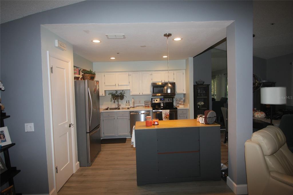810 Loch Calder, Unit 25 Apopka, FL 32712 - Photo 4 of 24 a room with stainless steel appliances kitchen island granite countertop a refrigerator and a stove top oven