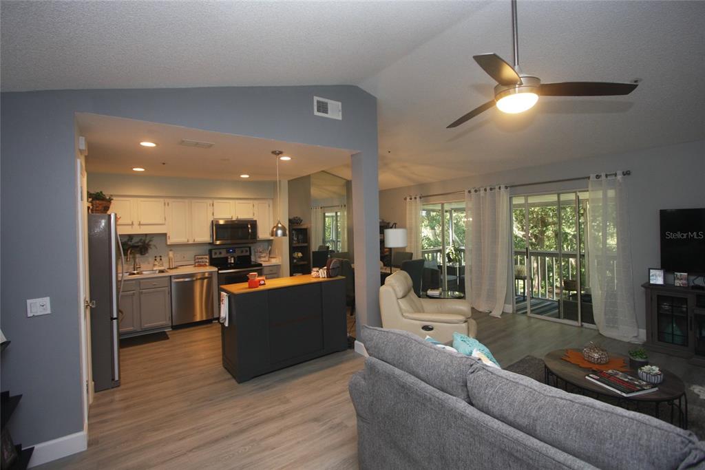 810 Loch Calder, Unit 25 Apopka, FL 32712 - Photo 6 of 24 a living room with furniture and kitchen view