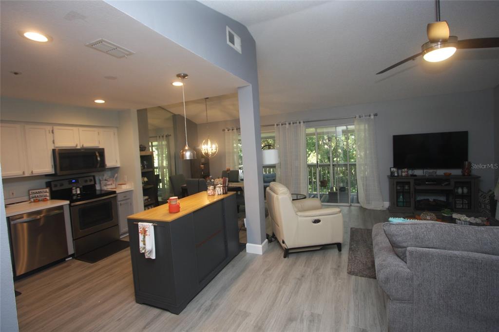 810 Loch Calder, Unit 25 Apopka, FL 32712 - Photo 7 of 24 a large living room with furniture and a flat screen tv