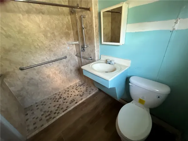 a bathroom with a sink toilet and shower
