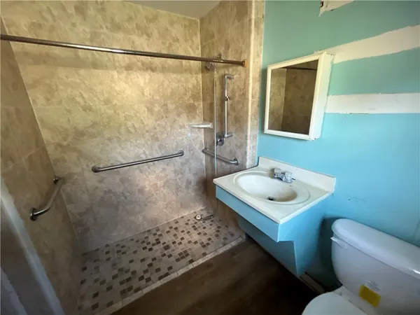 a bathroom with a sink toilet and shower
