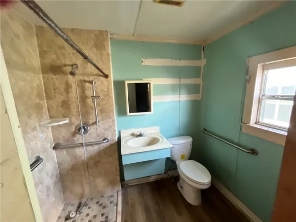 a bathroom with a sink toilet and shower