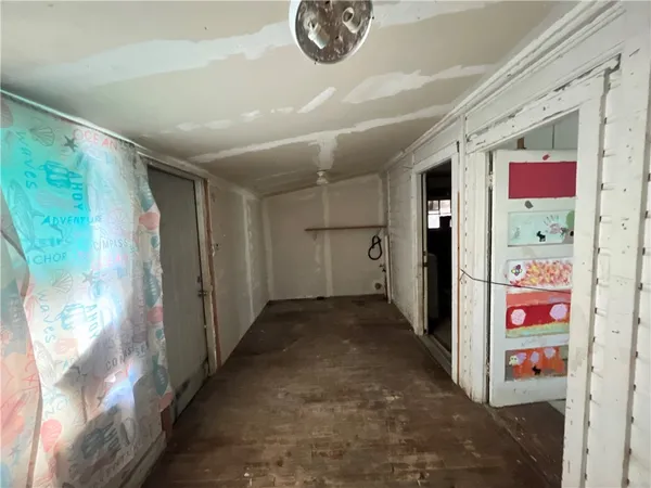 a view of a entryway door with wooden floor and stairs