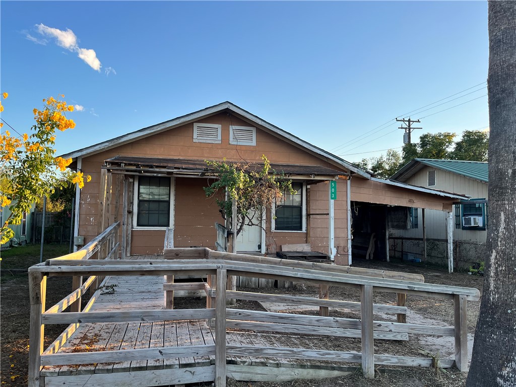 503 Johnson Street Freer, TX 78357 - Photo 2 of 24 a front view of a house with a porch