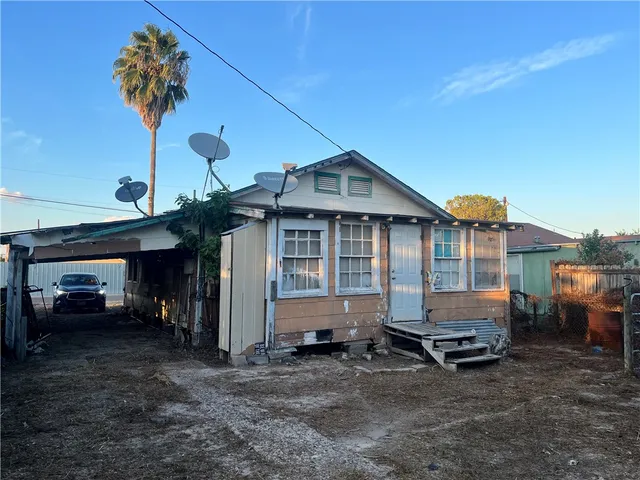a front view of a house with parking space