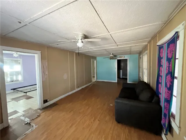 a living room with furniture and a ceiling fan
