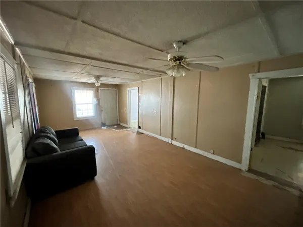 a living room with furniture and a ceiling fan