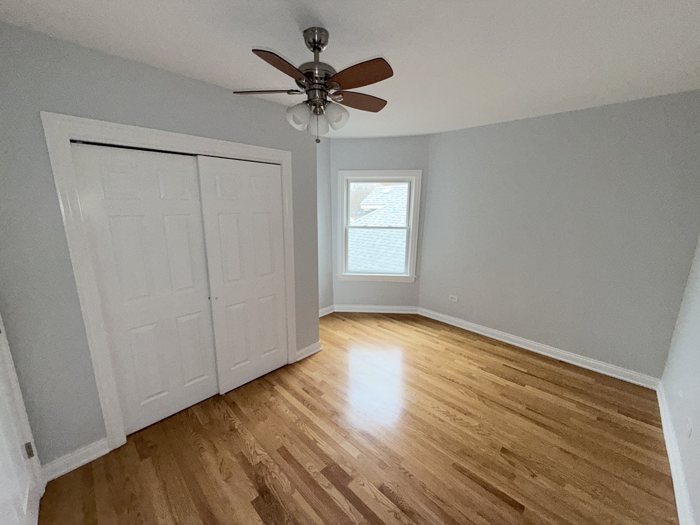 4204 North Melvina Avenue, Unit 2 Chicago, IL 60634 - Photo 6 of 12 a view of empty room with wooden floor and fan