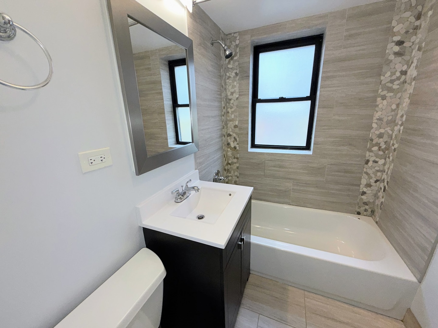 4204 North Melvina Avenue, Unit 2 Chicago, IL 60634 - Photo 10 of 12 a bathroom with a sink a toilet and bathtub