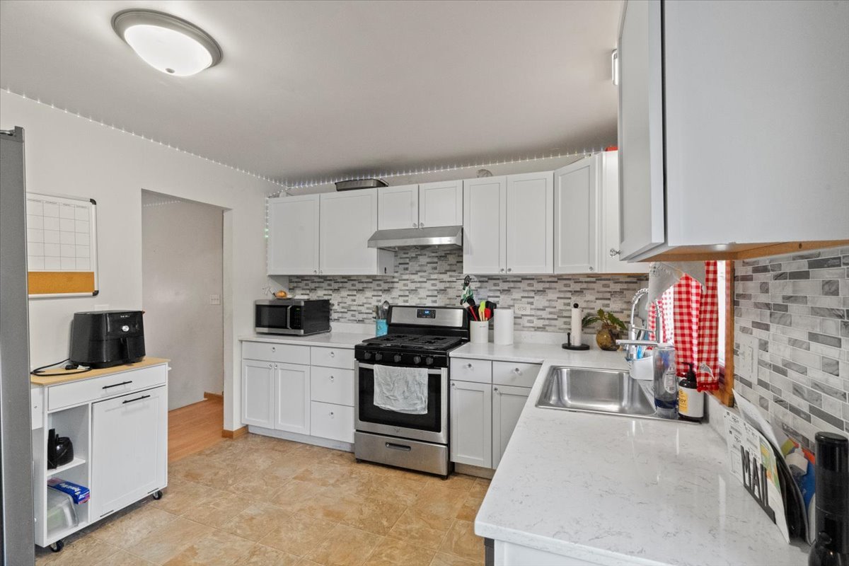 3507 Atlantic Avenue Gurnee, IL 60031 - Photo 12 of 33 a kitchen with stainless steel appliances a stove a sink a microwave and cabinets