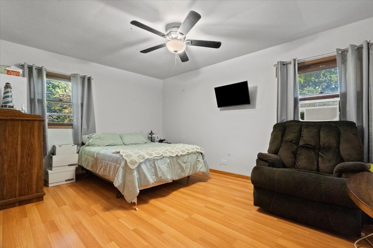 3507 Atlantic Avenue Gurnee, IL 60031 - Photo 15 of 33 a bedroom with a bed a couch and a flat tv screen on dresser