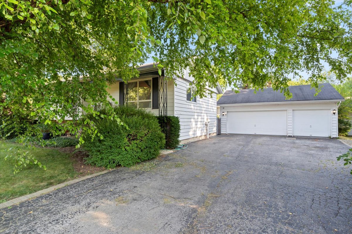 3507 Atlantic Avenue Gurnee, IL 60031 - Photo 3 of 33 a front view of a house with a yard and a garage