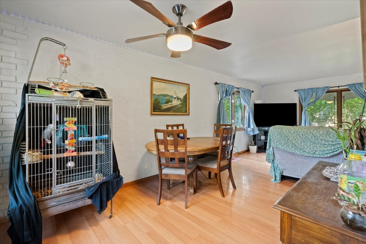 3507 Atlantic Avenue Gurnee, IL 60031 - Photo 10 of 33 a view of a livingroom with furniture and a dining table with wooden floor