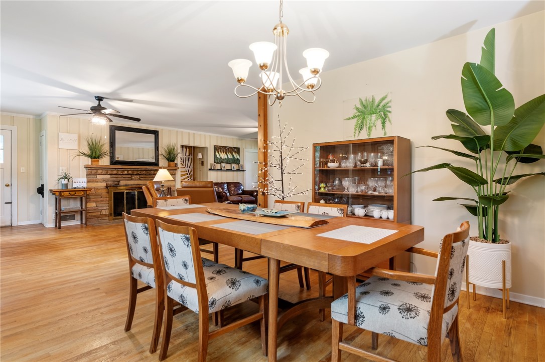 1105 Greenacres Anderson, SC 29621 - Photo 12 of 46 Hardwood floors stretch across this inviting dining room, anchored by a classic chandelier.