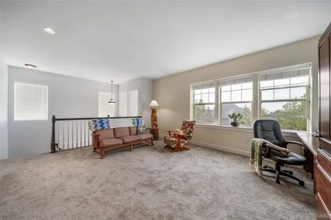a spacious bedroom with a bed and a chandelier