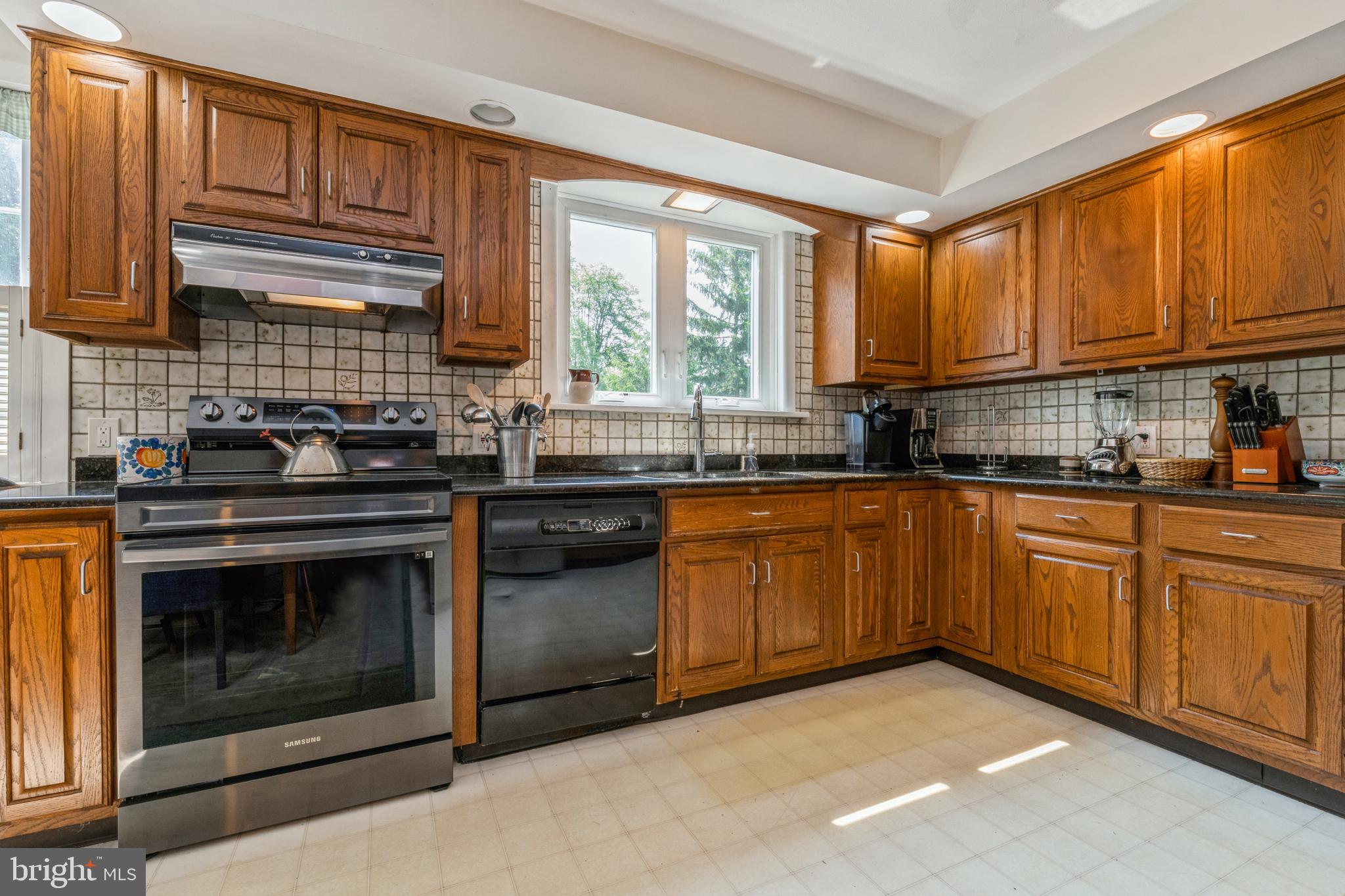 7 Perry Drive Ewing, NJ 08628 - Photo 16 of 39 a kitchen with stainless steel appliances granite countertop a stove a sink and a microwave