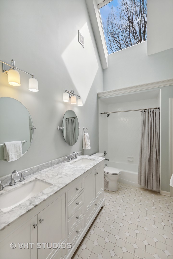705 Fox Glen Drive St. Charles, IL 60174 - Photo 26 of 49 a bathroom with a granite countertop sink mirror vanity and toilet