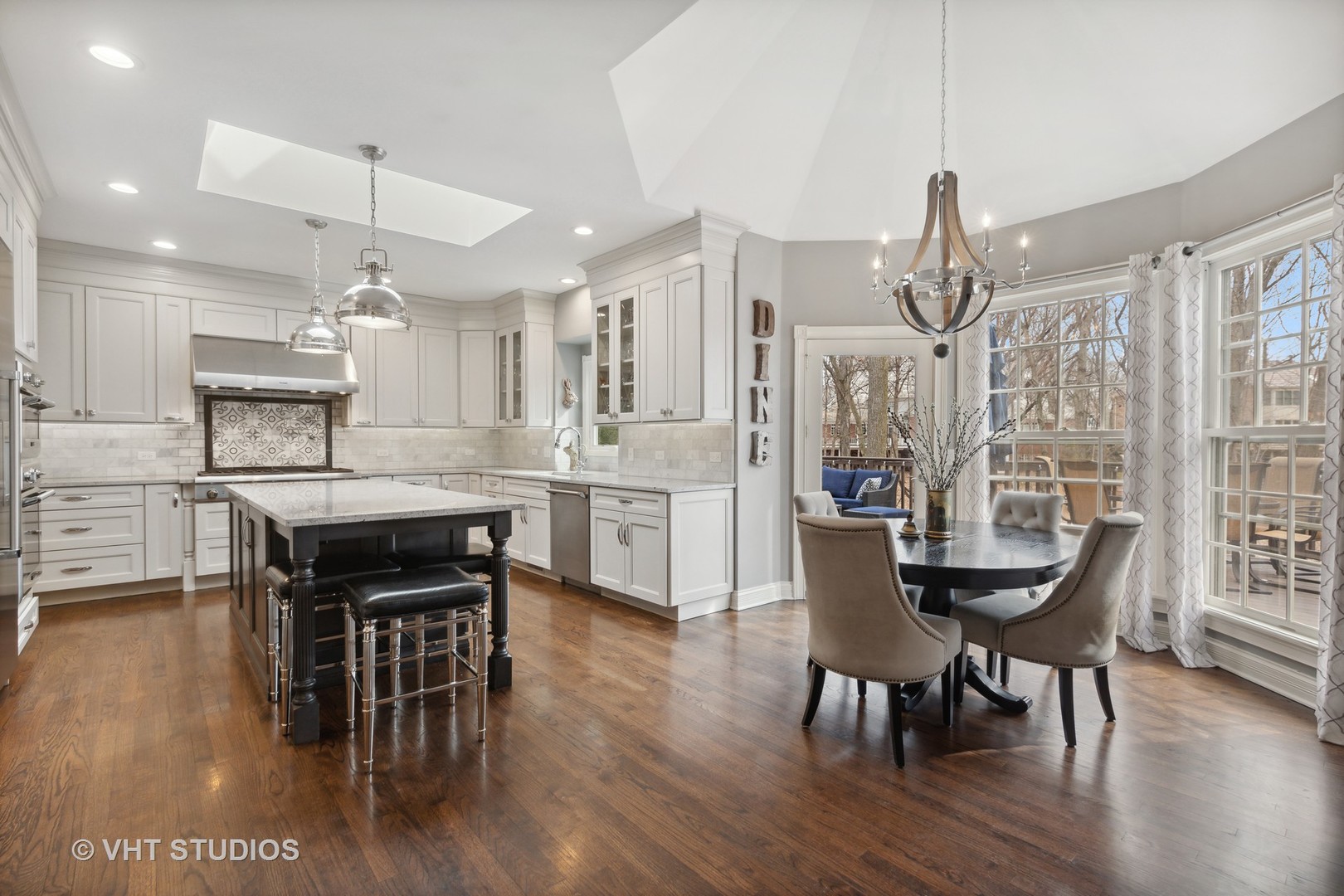 705 Fox Glen Drive St. Charles, IL 60174 - Photo 3 of 49 a kitchen with stainless steel appliances kitchen island granite countertop a dining table chairs and white cabinets
