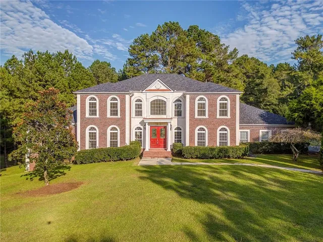 a front view of a house with a yard