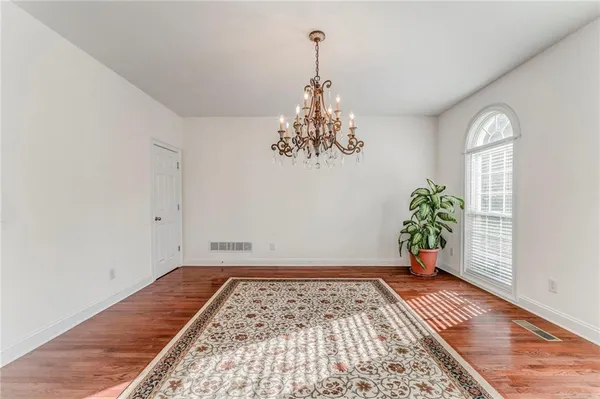 a view of a room with window and wooden floor