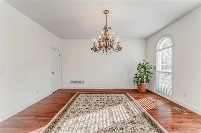a view of a room with window and wooden floor