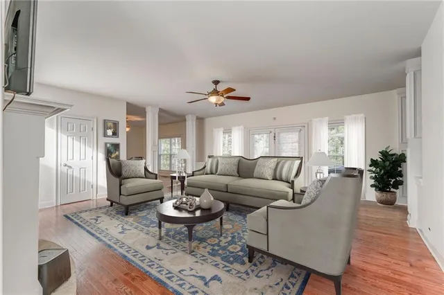 a living room with furniture and wooden floor