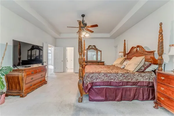 a bedroom with a bed and flat screen tv