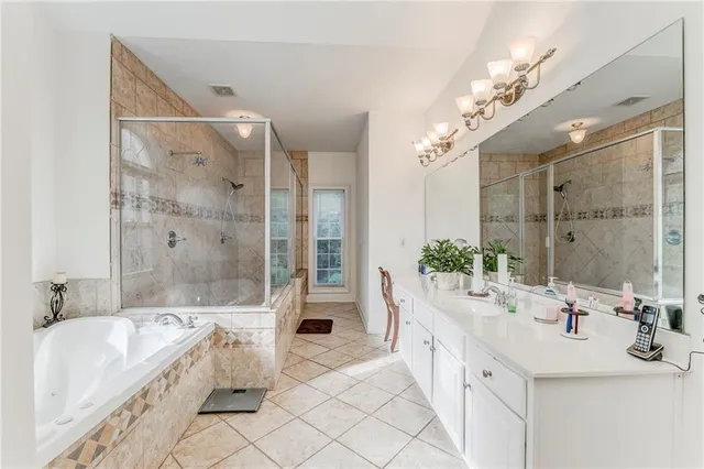 a spacious bathroom with a bathtub shower sink and mirror