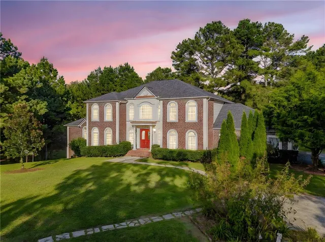 a front view of a house with a garden