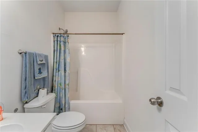 a bathroom with a toilet and shower