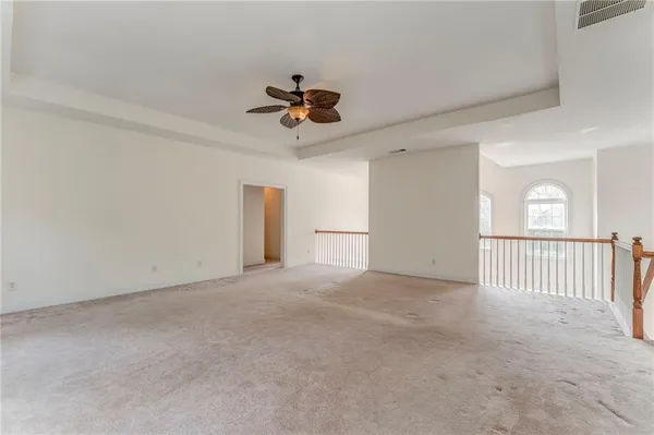 a view of a livingroom with a ceiling fan and window