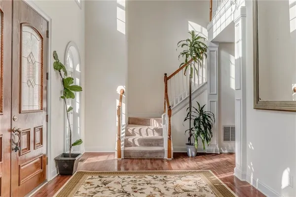 a living room filled with furniture and a potted plant