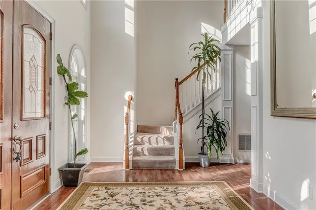 a living room filled with furniture and a potted plant