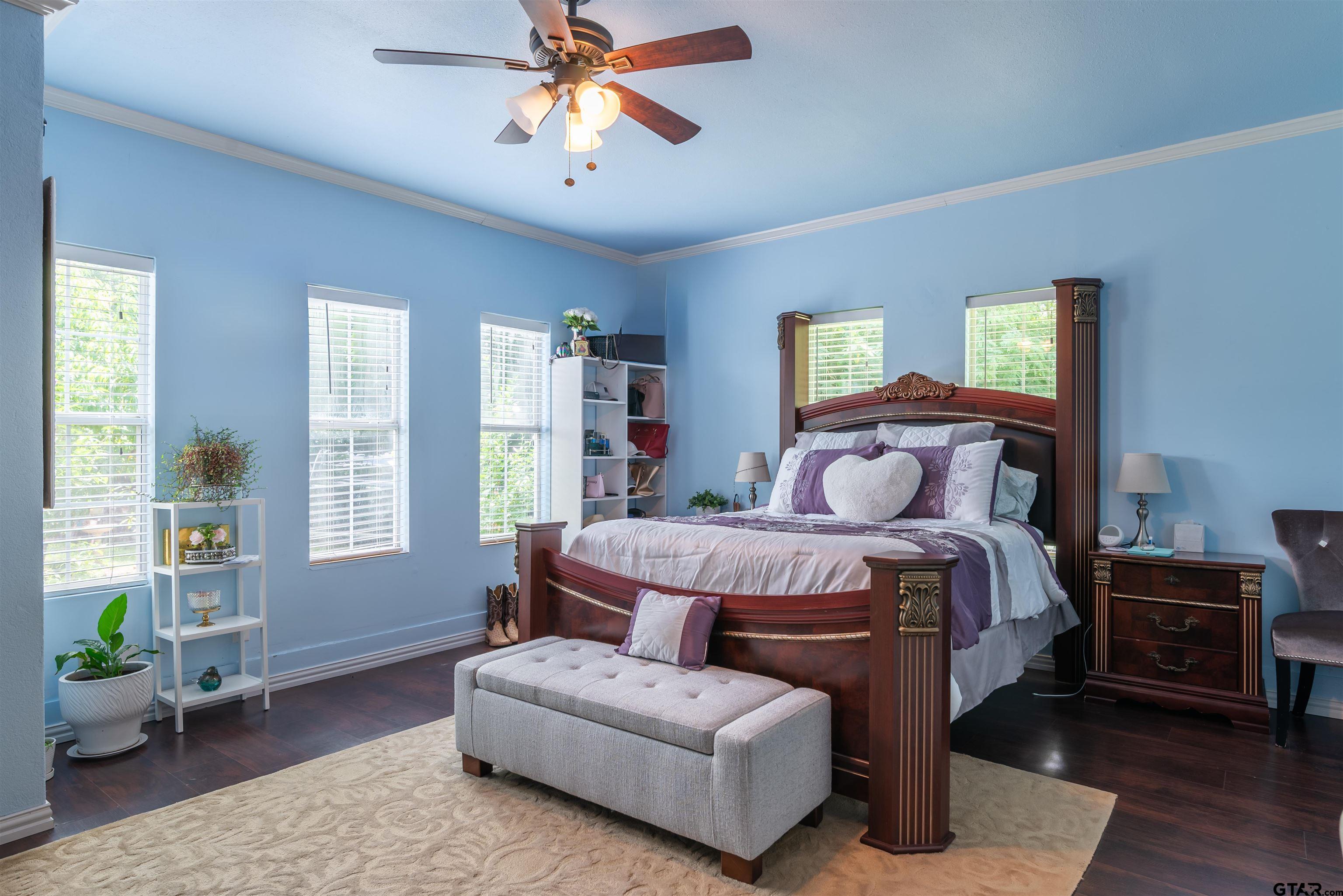 427 East Locust Street Tyler, TX 75702 - Photo 15 of 42 a bedroom with a bed a couch and potted plant on the dresser