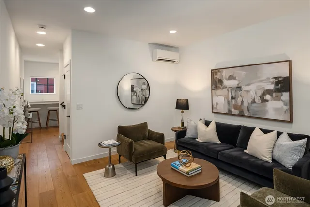 a living room with furniture and wooden floor