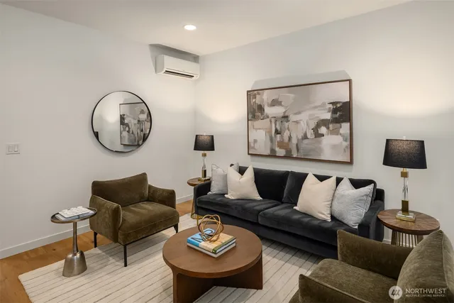 a living room with furniture and a wooden floor