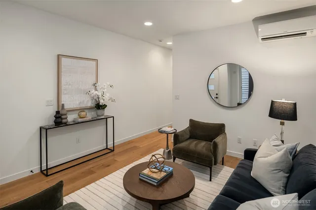 a living room with furniture and a mirror
