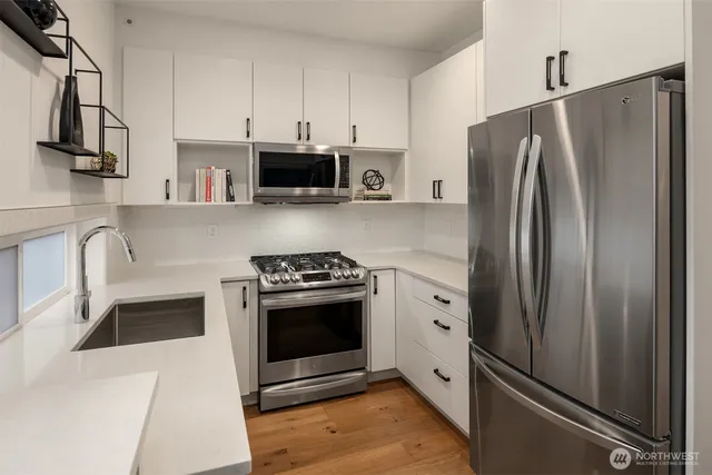 a kitchen with stainless steel appliances a refrigerator stove and sink