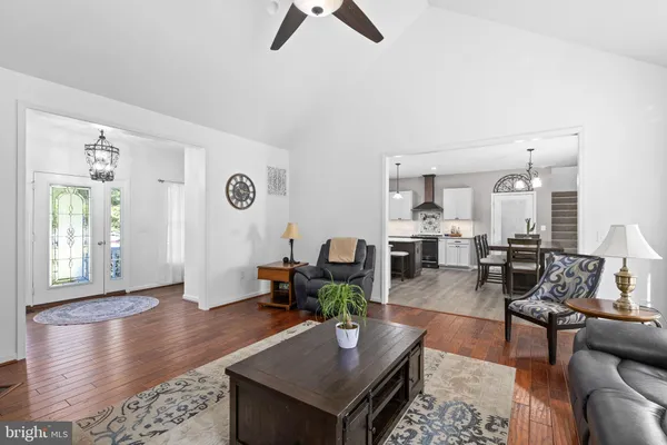 a kitchen with stainless steel appliances granite countertop a stove a refrigerator and a white cabinets