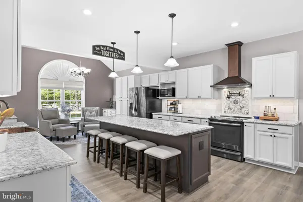 a kitchen with stainless steel appliances granite countertop a sink stove and cabinets
