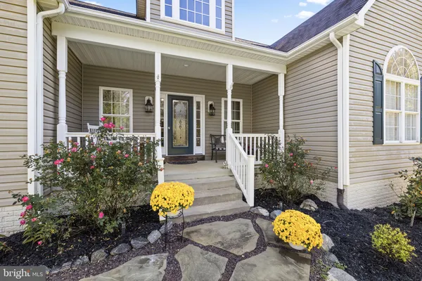 a view of a hallway view with furniture and wooden floor