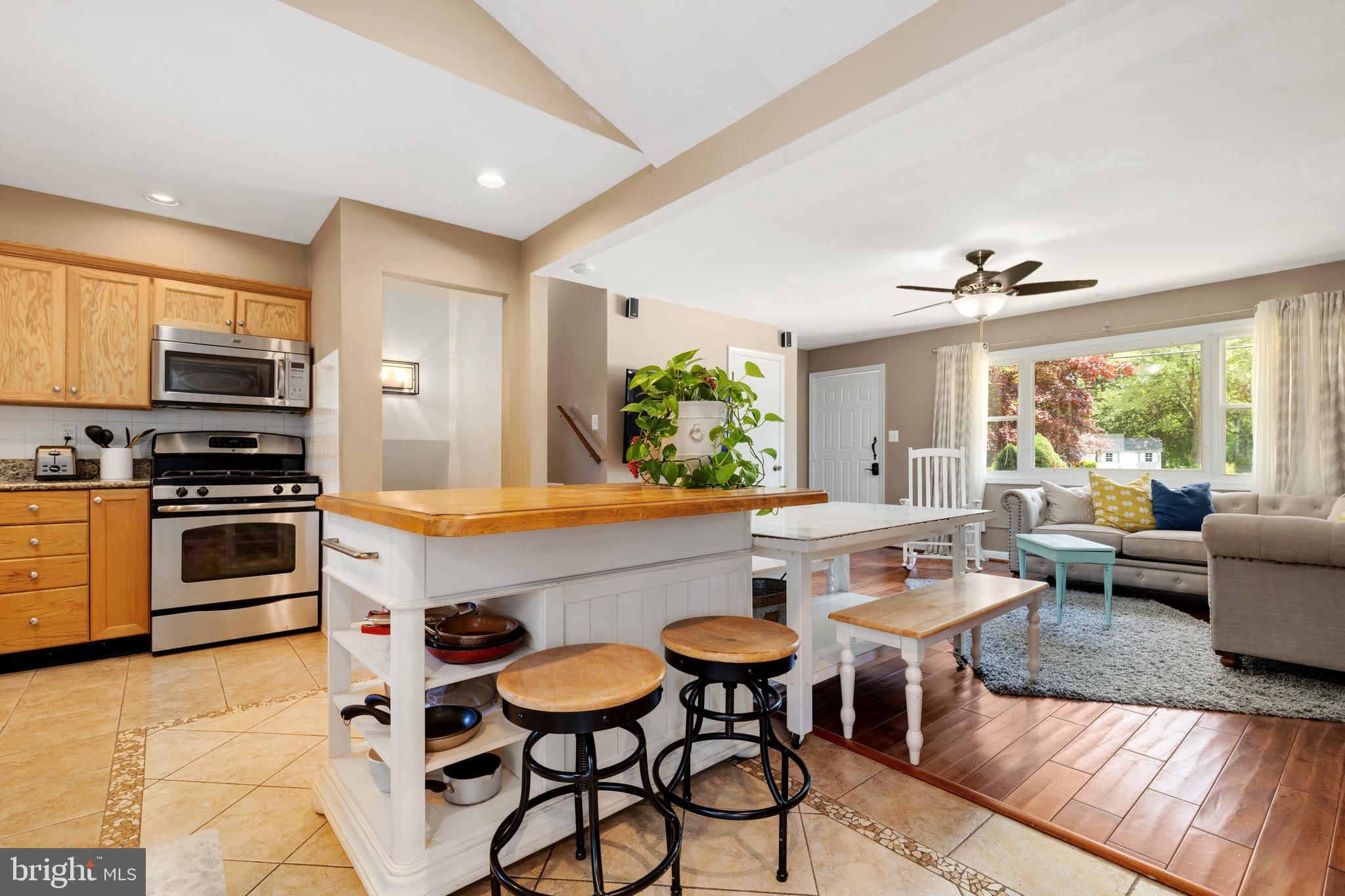 133 Valley View Avenue Edgewater, MD 21037 - Photo 3 of 41 a kitchen with stainless steel appliances kitchen island granite countertop a sink and a refrigerator