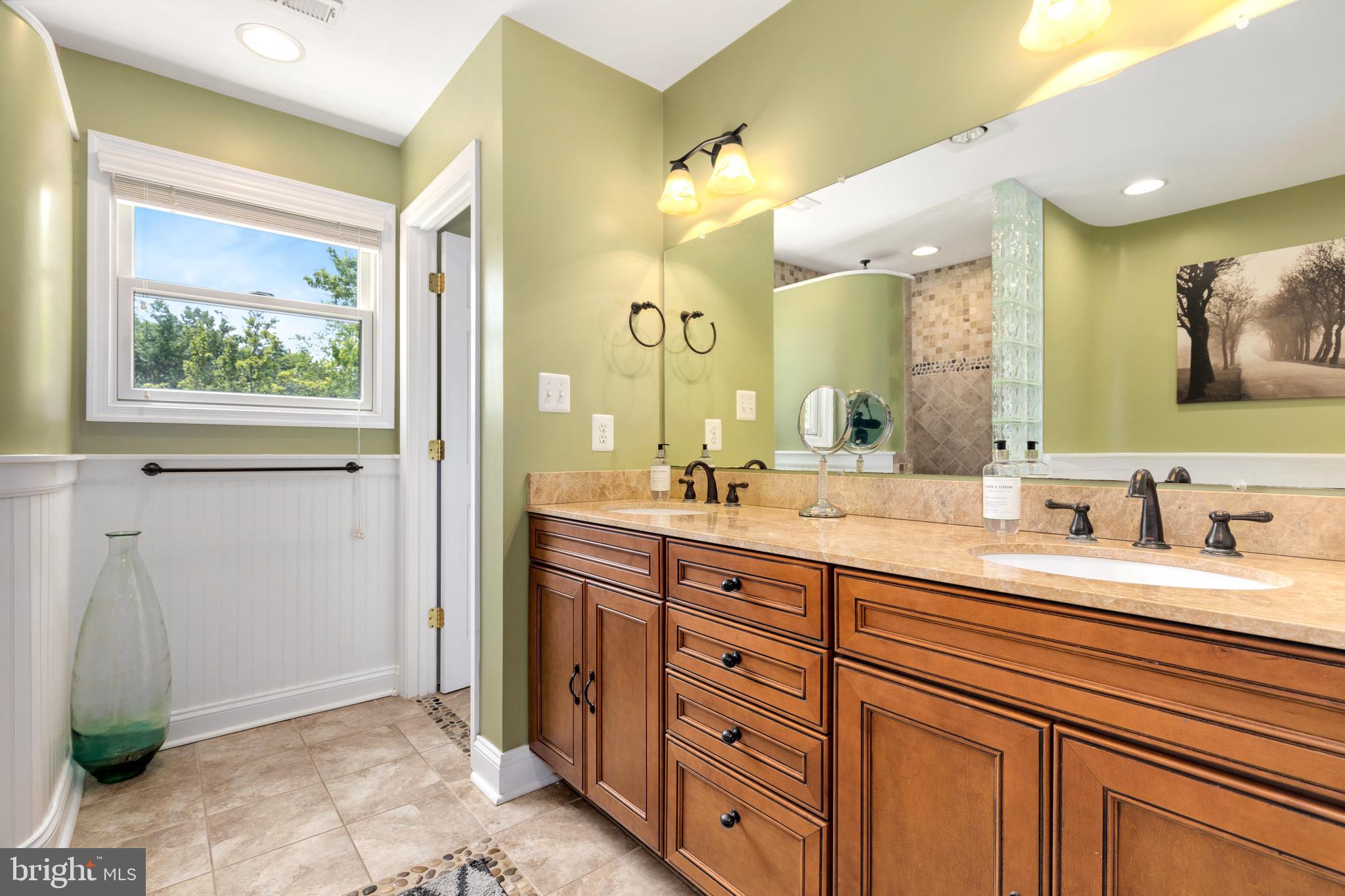 133 Valley View Avenue Edgewater, MD 21037 - Photo 6 of 41 a spacious bathroom with a double vanity sink and a mirror