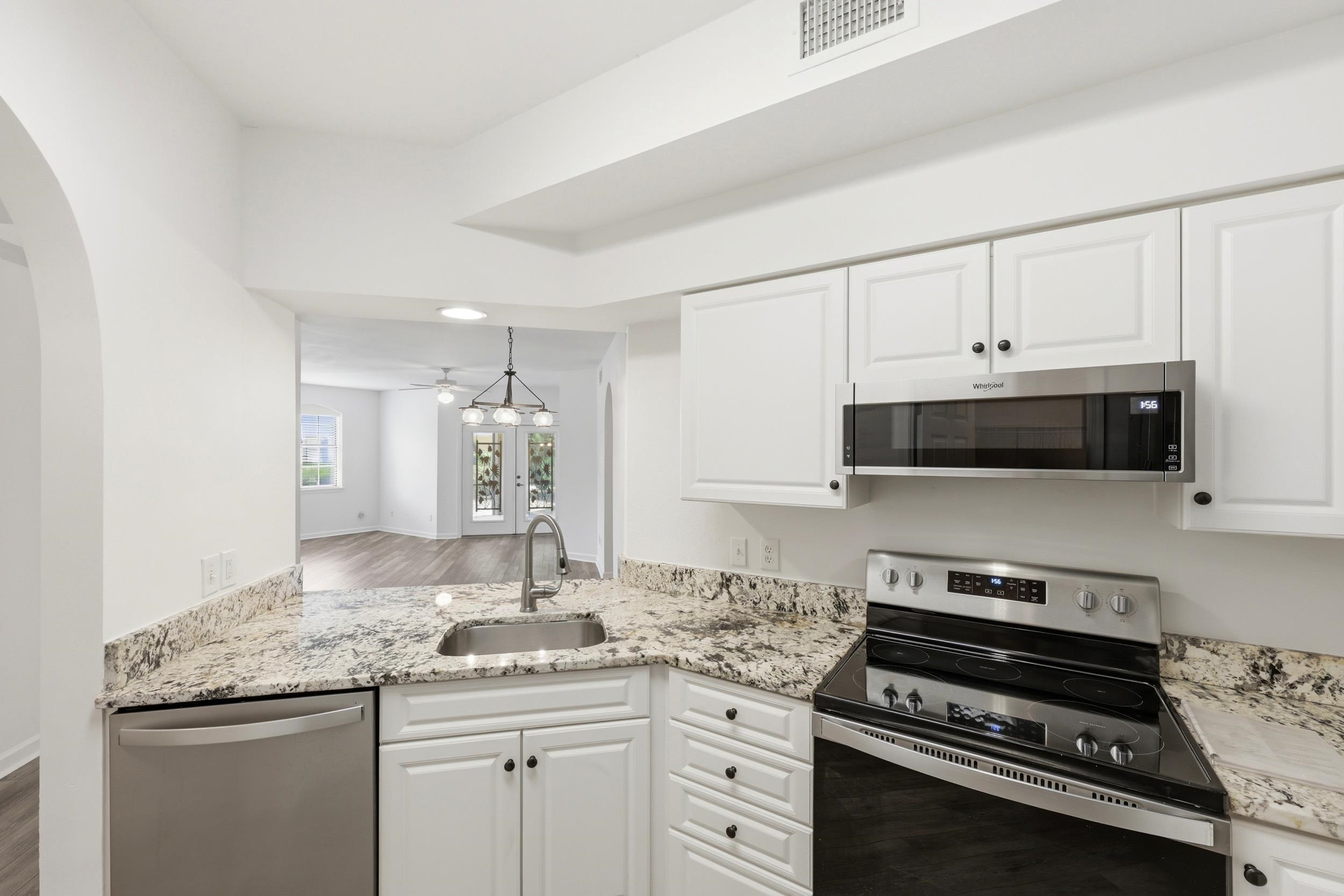 2500 Vista Cove Road St. Augustine, FL 32084 - Photo 11 of 53 a kitchen with granite countertop a stove and a sink