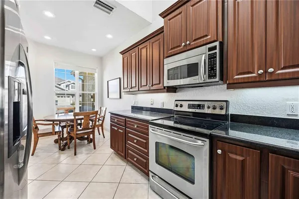 a kitchen with stainless steel appliances a stove microwave and cabinets